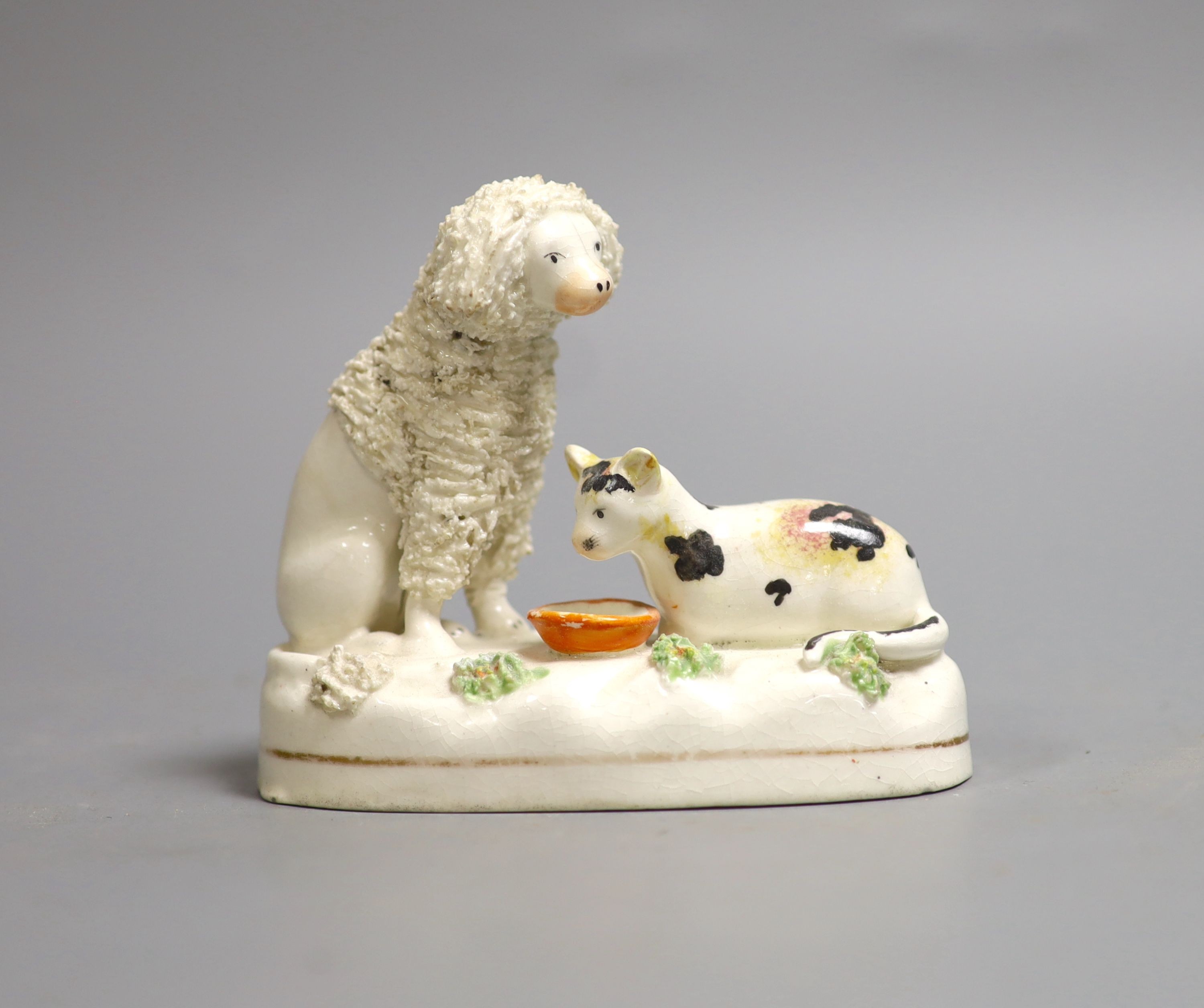 A Staffordshire porcelain group of a poodle and a cat, c.1830-50, 11 cm long